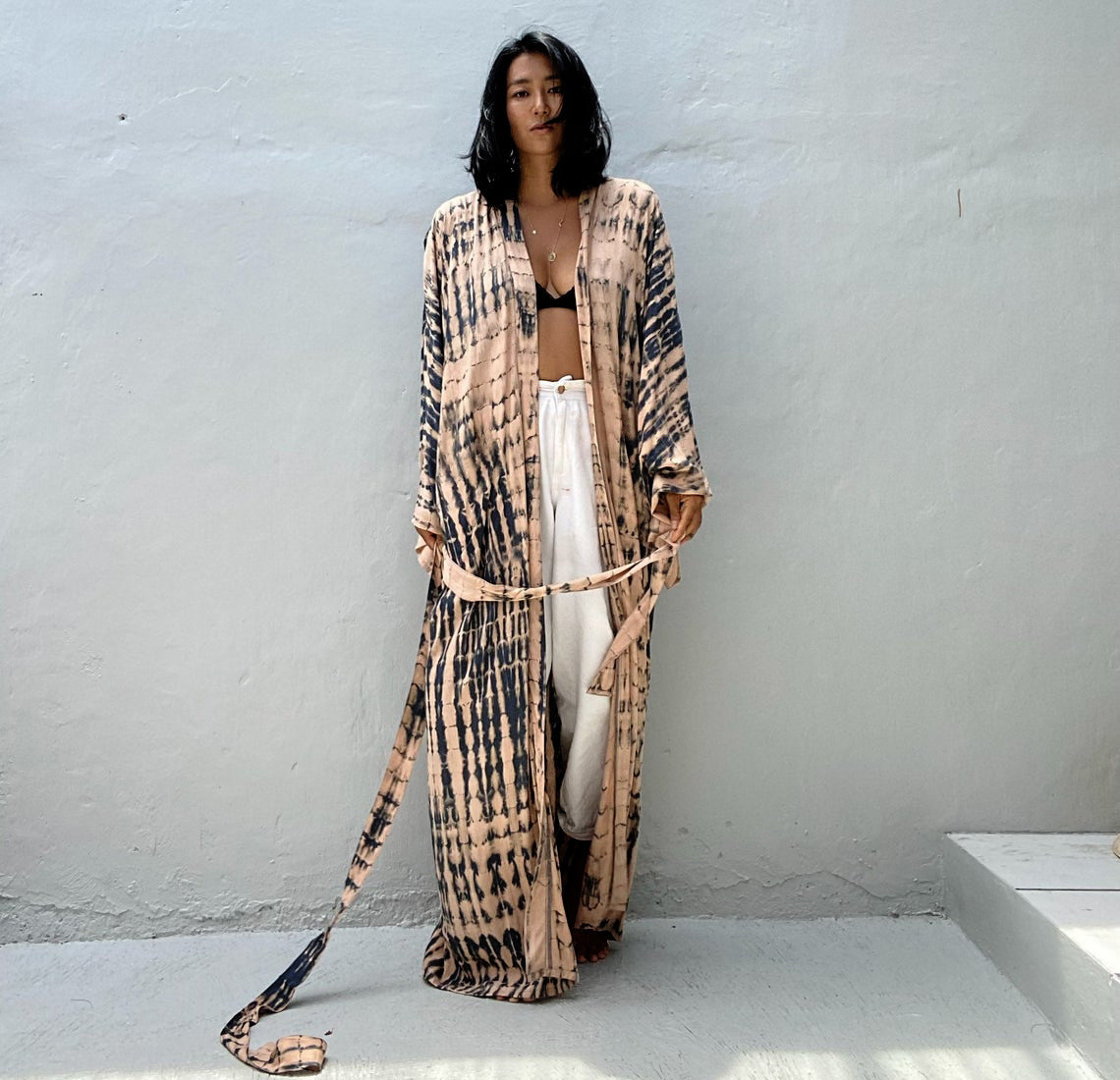 Women wearing Trenches of Mariana rayon tie-dye beach cover-up with sun protection, loose fit, ideal for vacation over swimsuits.