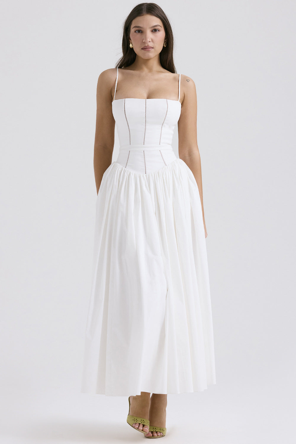 Trenches of Mariana women's sleeveless long dress with spaghetti straps, printed flared skirt, low neckline, and waist-cinching design.