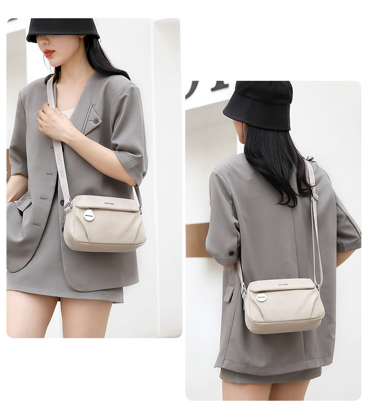 Lightweight water-repellent nylon crossbody bag by Trenches of Mariana, stylish small women's shoulder bag for casual use.