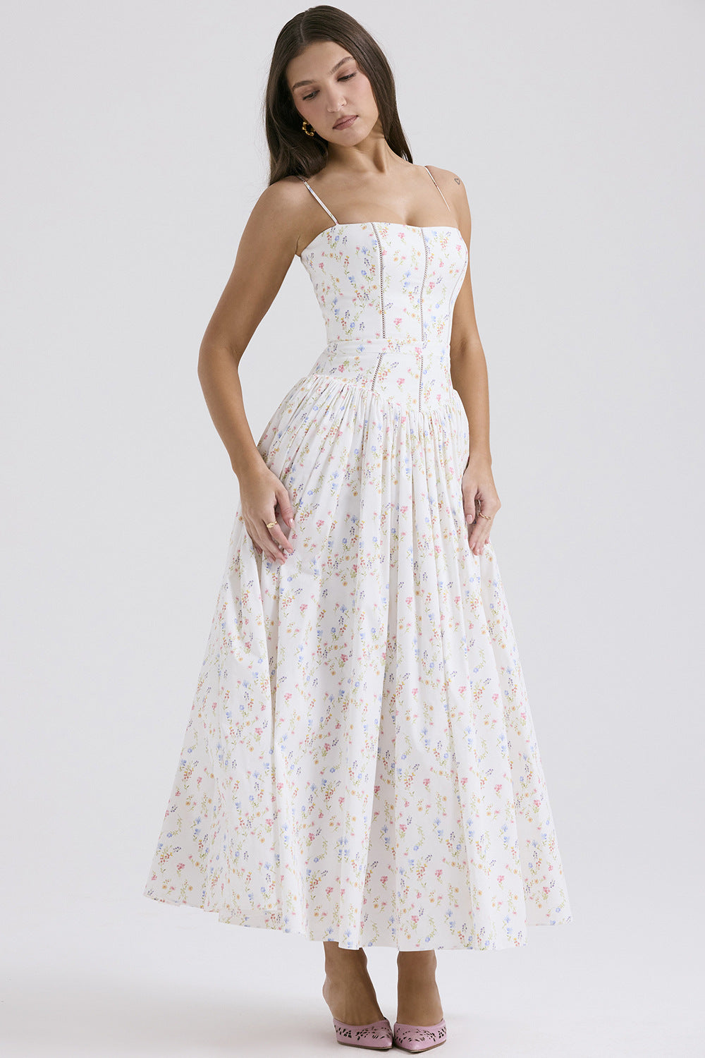 Trenches of Mariana women's sleeveless printed flared long dress with spaghetti straps, low neck, and waist-cinching design.