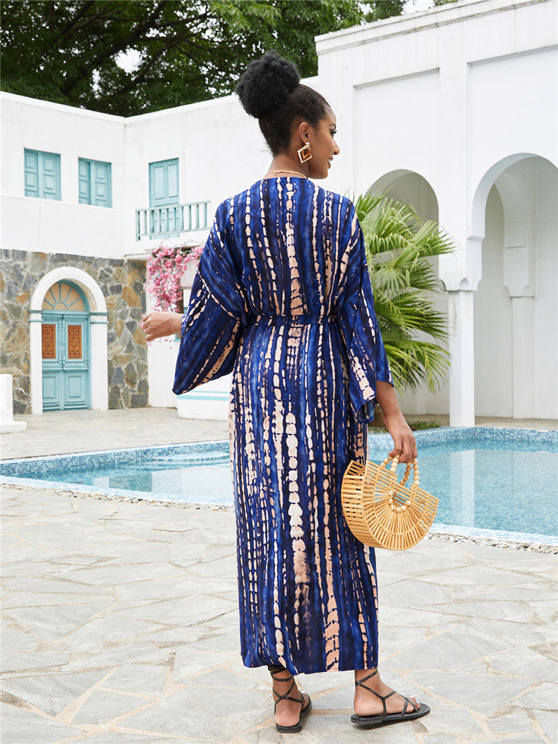 Women wearing Trenches of Mariana rayon tie-dye beach cover-up with sun protection, loose fit, perfect for vacation and swimsuit outings.