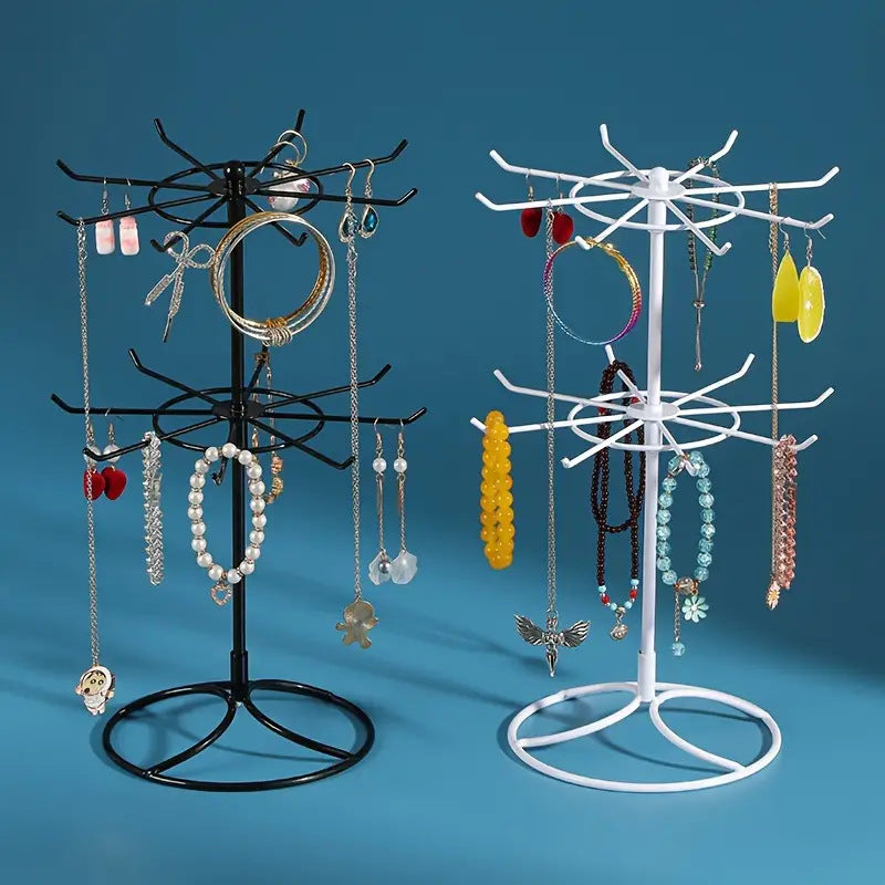 Rotating jewelry display rack with two-layer shelf for necklaces and bracelets, by Trenches of Mariana, showcasing organized jewelry.