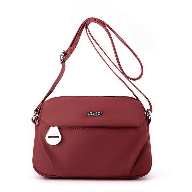 Lightweight water-repellent nylon crossbody bag by Trenches of Mariana, stylish women's shoulder bag for casual, all-match outfits.