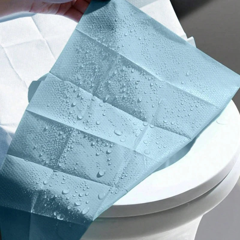 Disposable toilet seat covers from Trenches of Mariana, waterproof paper mats for travel, hotel, and home bathroom use.