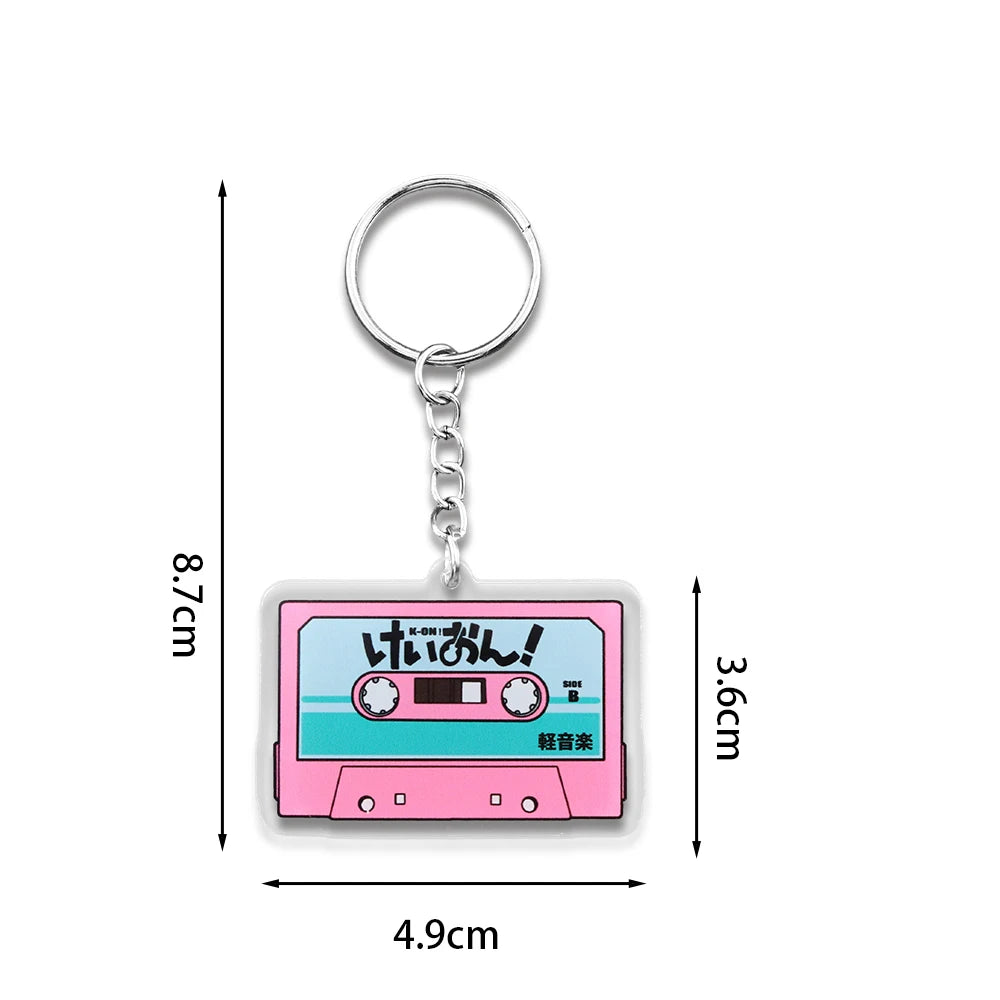 Pink K-On! cassette tape acrylic keychain featuring the HTT band from Japanese anime, with a fun, portable pendant design.