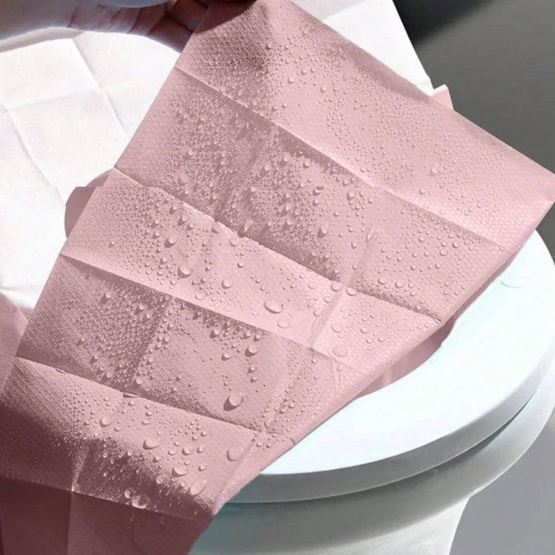 Disposable toilet seat covers by Trenches of Mariana, waterproof and portable paper mats for hotel, travel, and home bathroom use.