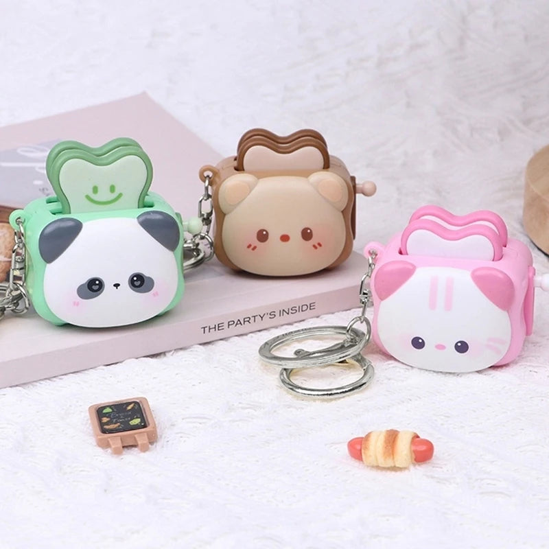Cute bread machine panda keychain by Trenches of Mariana, a charming cartoon stress-relief accessory and small gift.