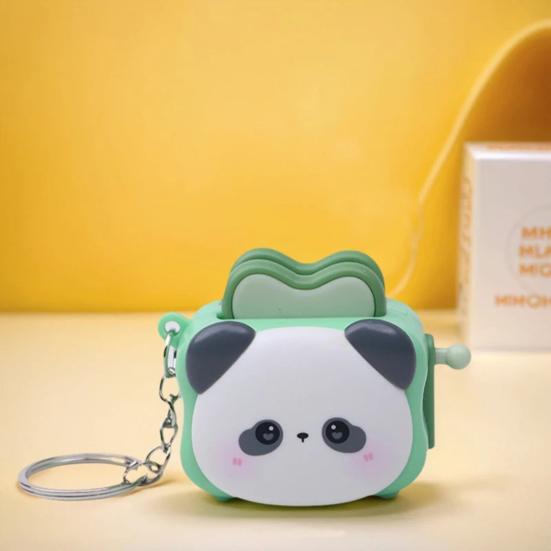 Cute bread machine panda keychain by Trenches of Mariana, featuring a cartoon panda design, perfect as a small stress-relief accessory.