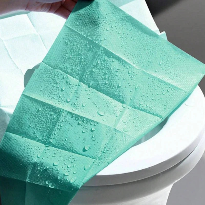 Disposable toilet seat covers from Trenches of Mariana, waterproof and portable paper mats for travel, hotel, and home bathroom use.