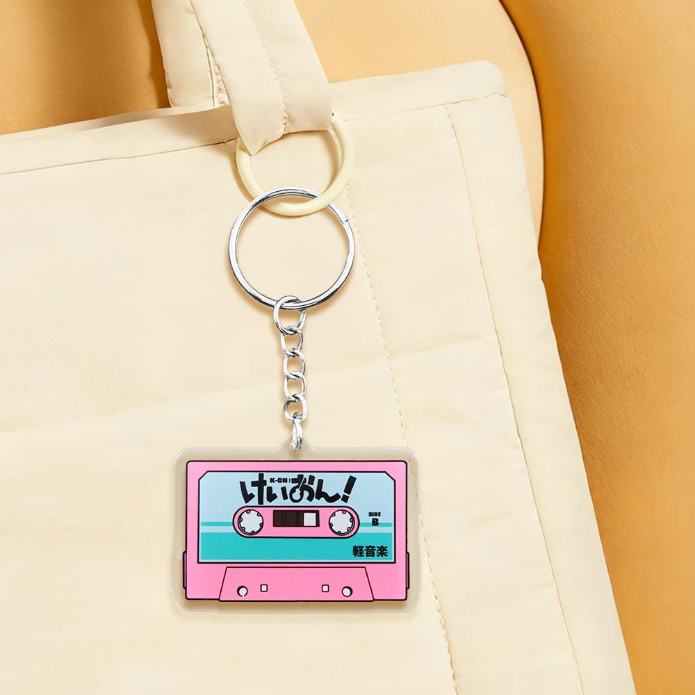 Pink K-On! cassette tape acrylic keychain featuring HTT band logo, anime-themed pendant, and Japanese-style design.