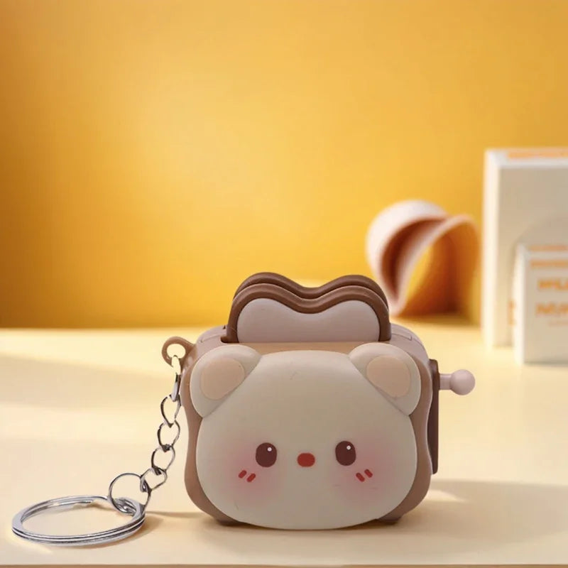 Cute panda bread machine keychain by Trenches of Mariana, a charming stress-relief accessory and small cartoon gift.