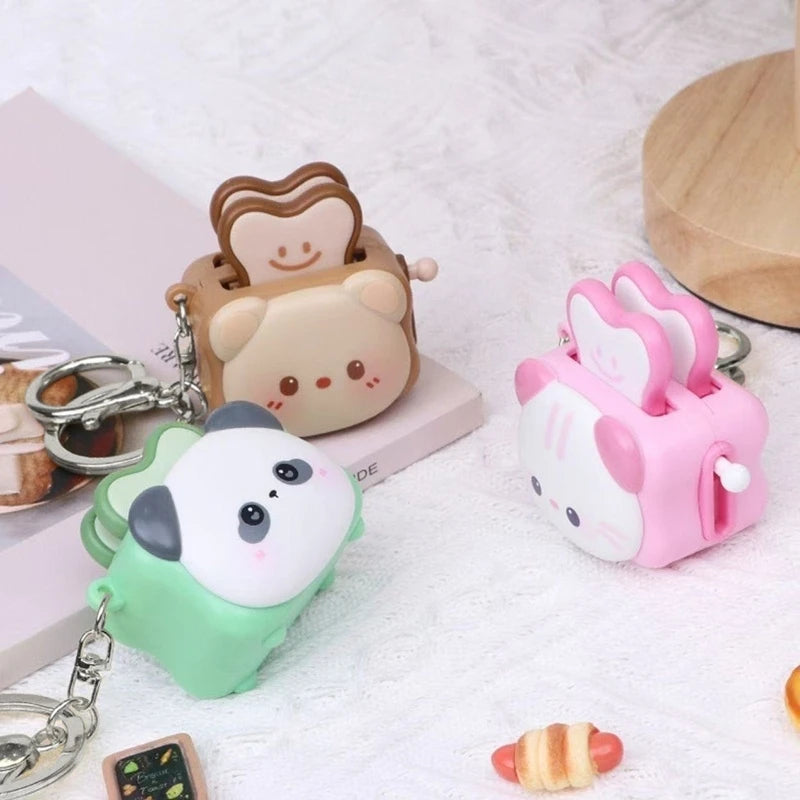 Cute bread machine panda keychain from Trenches of Mariana, a cartoon stress-relieving accessory and small gift.