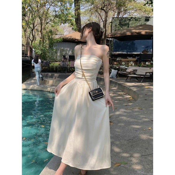 Bride on vacation wearing a Trenches of Mariana Bride-On-Vacay Dress, featuring a flowing white fabric and elegant design.