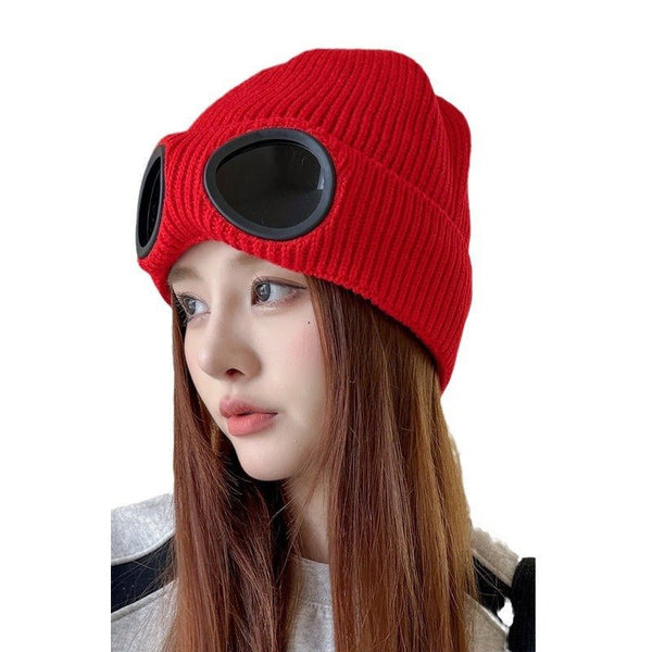 Ribbed knitted beanie with glasses design by Trenches of Mariana, featuring a playful eyes pattern for winter accessories.
